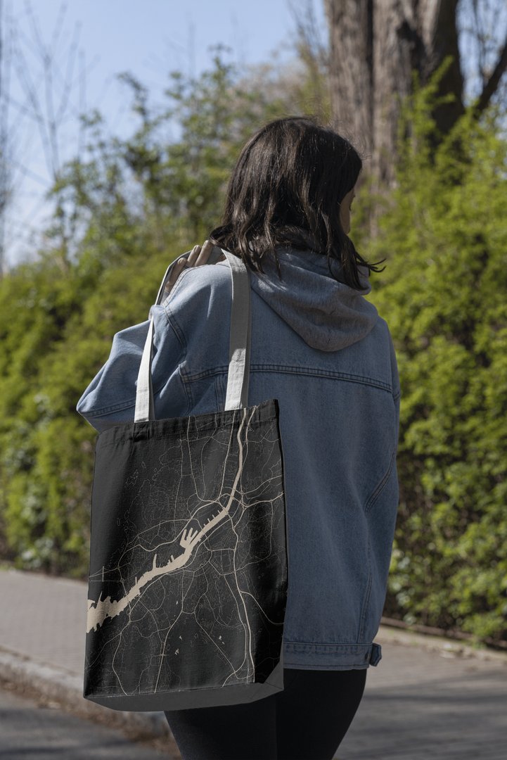 Tote bag carrying the Gothenburg map graphic, worn outdoors